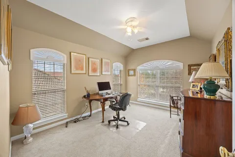 a bathroom with a sink a toilet a mirror and shower