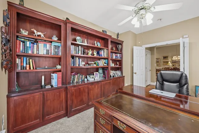 a living room with hard wood floors and a book shelf