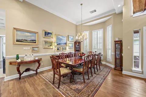 a dining room with furniture window and wooden floor