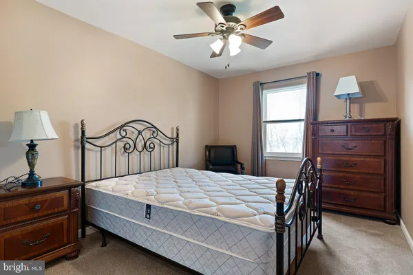 a bedroom with a bed and a dresser
