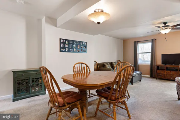 a view of a dining room with furniture and chandelier