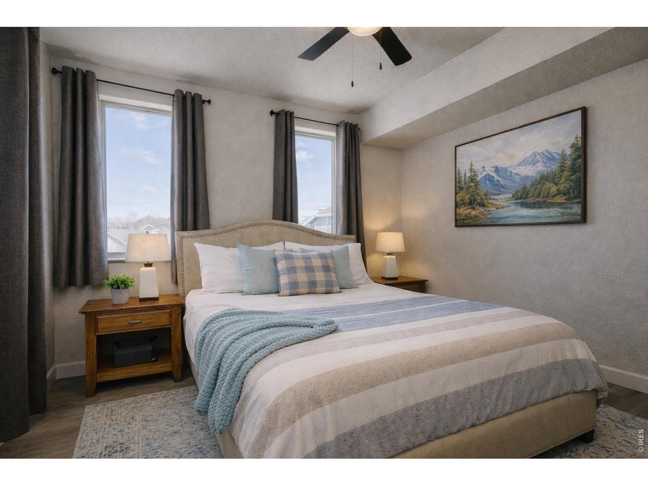 1802 Wildfire Road, Unit 204 Estes Park, CO 80517 - Photo 20 of 35 a bedroom with a large bed and a chandelier