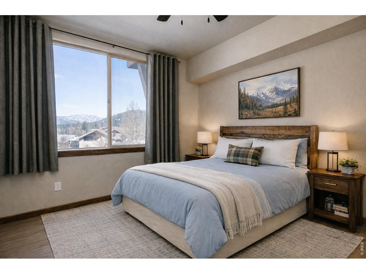 1802 Wildfire Road, Unit 204 Estes Park, CO 80517 - Photo 21 of 35 a bedroom with a large bed and a large window
