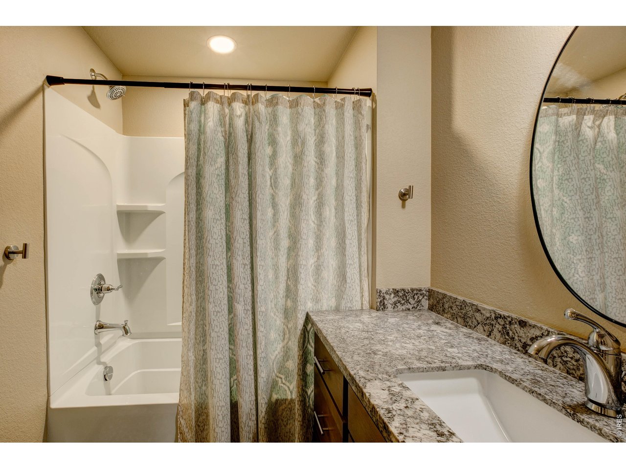 1802 Wildfire Road, Unit 204 Estes Park, CO 80517 - Photo 22 of 35 a bathroom with a granite countertop sink a mirror and a shower