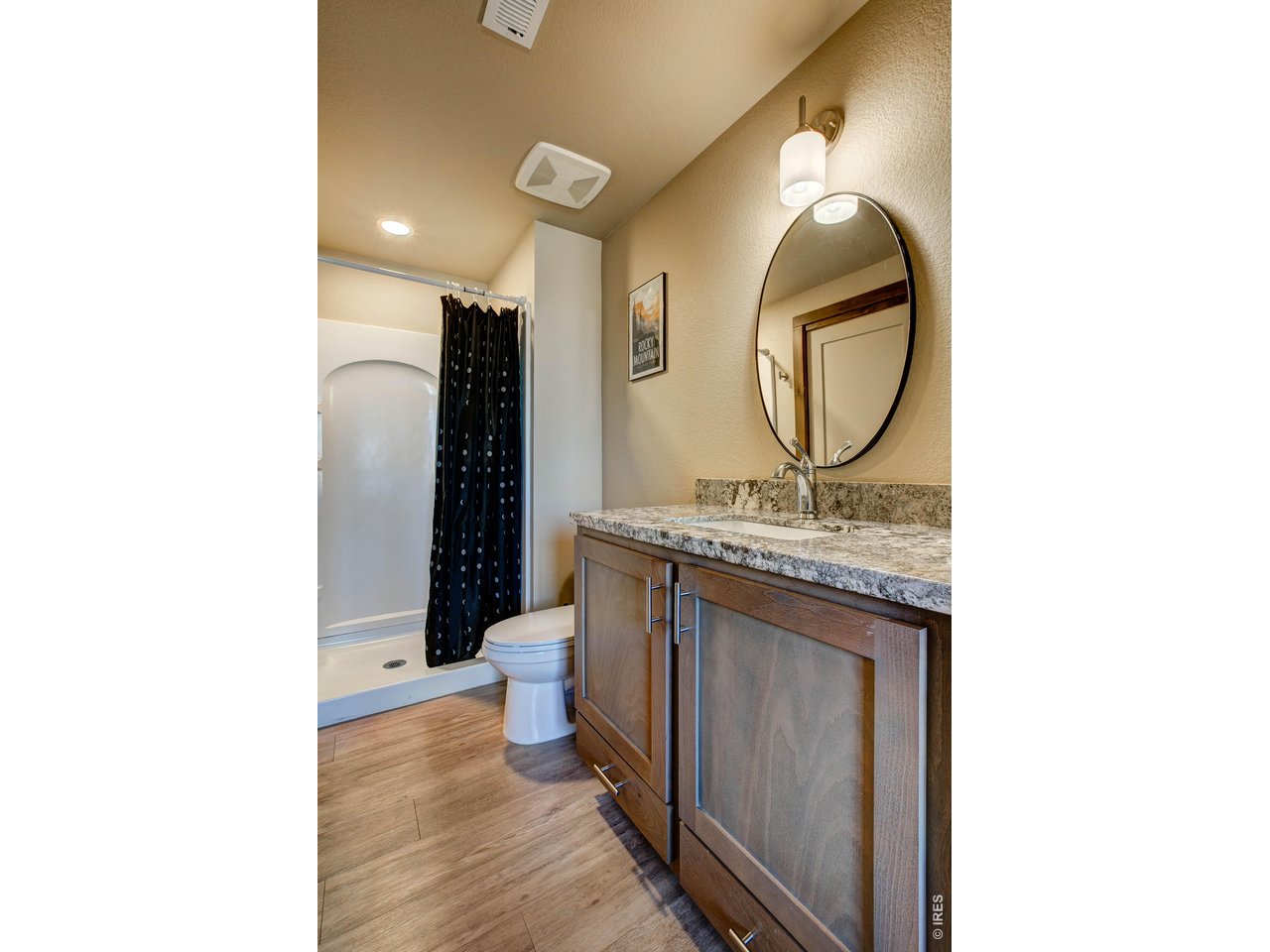 1802 Wildfire Road, Unit 204 Estes Park, CO 80517 - Photo 28 of 37 a bathroom with a granite countertop sink and a mirror
