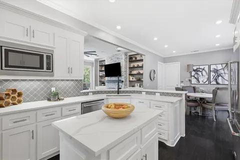 a kitchen with a stove a sink and a microwave