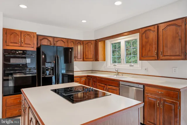 a kitchen that has a sink cabinets stainless steel appliances and a window
