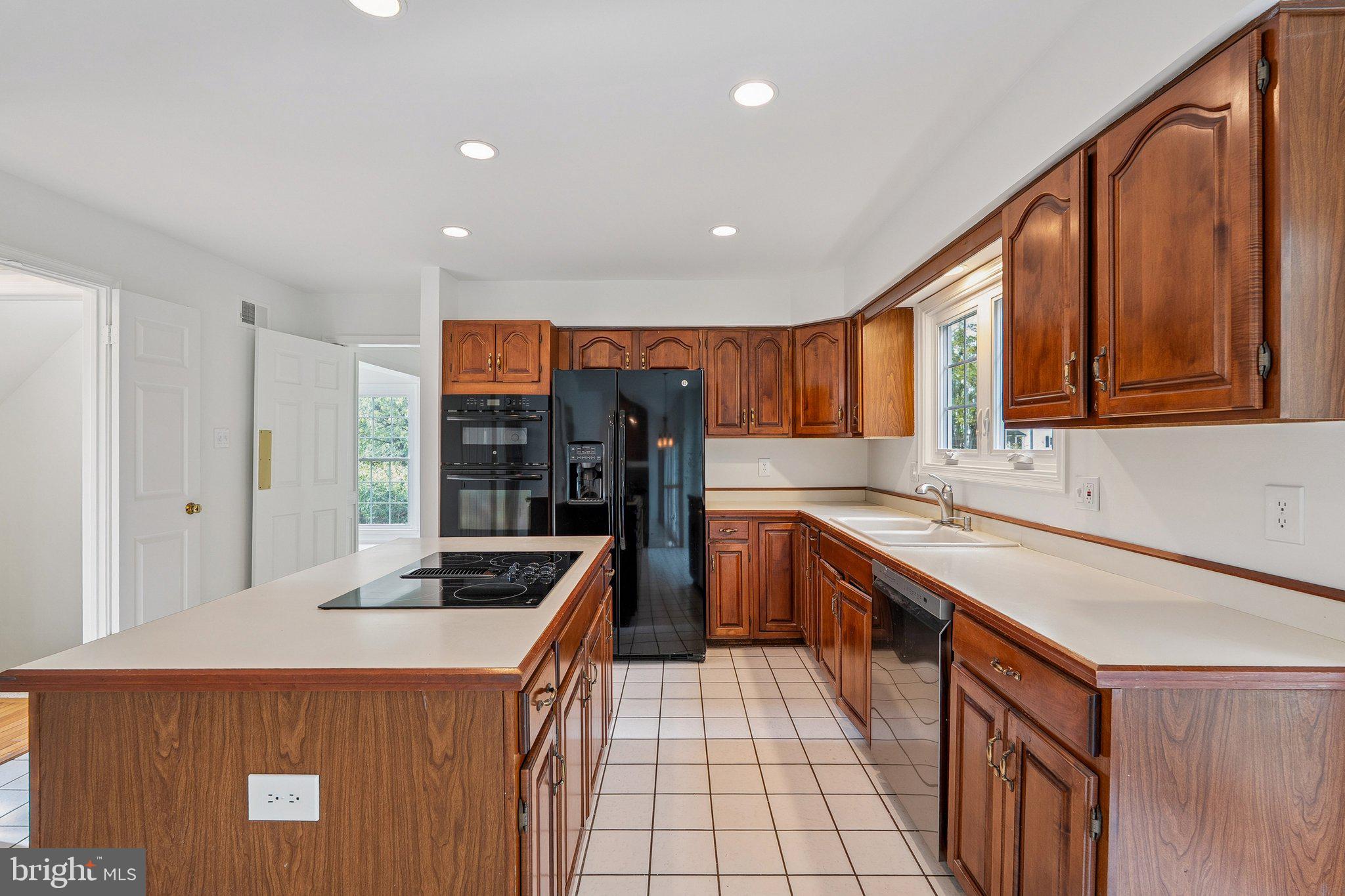 15056 Brown Post Lane Centreville, VA 20121 - Photo 13 of 45 a kitchen with stainless steel appliances granite countertop a sink and cabinets