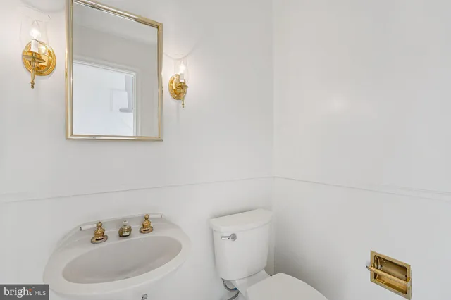 a white toilet sitting next to a bathroom sink