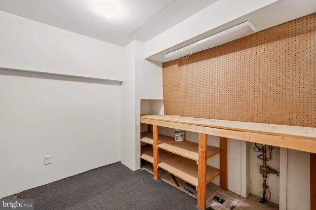 an empty room with an entryway and fan