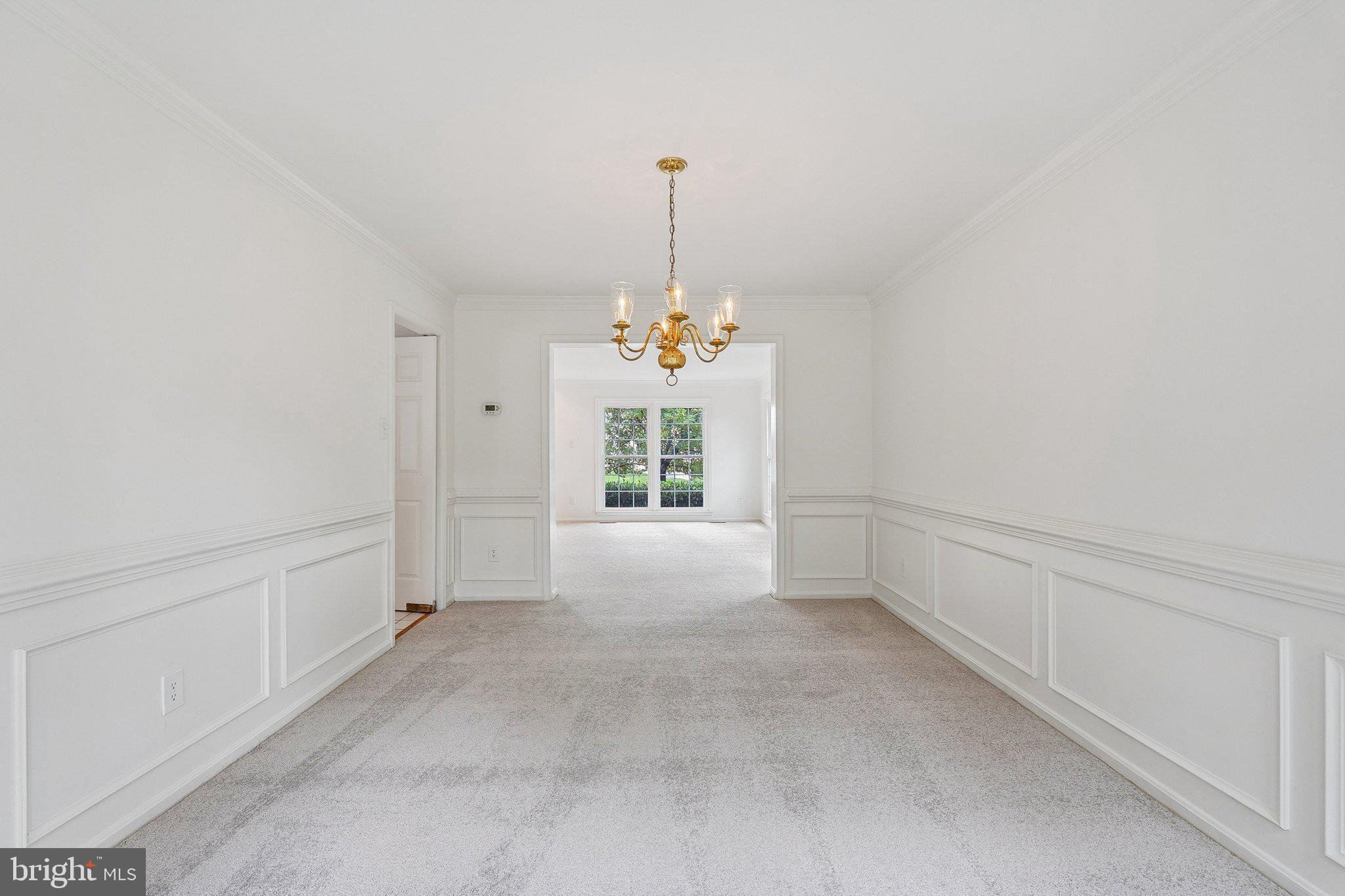 15056 Brown Post Lane Centreville, VA 20121 - Photo 9 of 45 a view of an empty room with chandelier fan and windows
