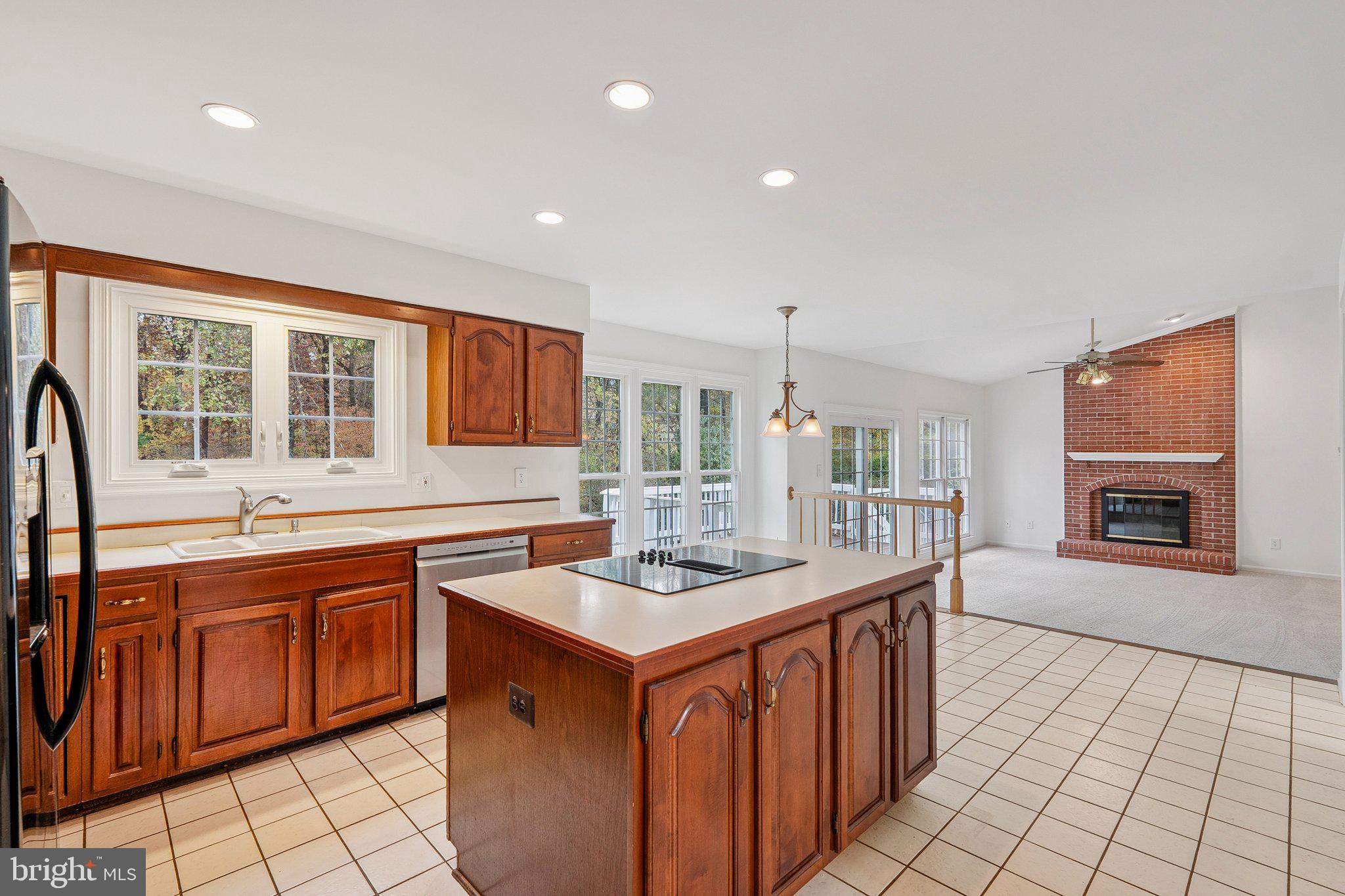 15056 Brown Post Lane Centreville, VA 20121 - Photo 10 of 45 a kitchen with stainless steel appliances granite countertop a stove a sink dishwasher and a refrigerator with wooden cabinets