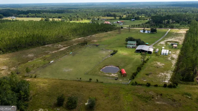 an aerial view of a house with a yard