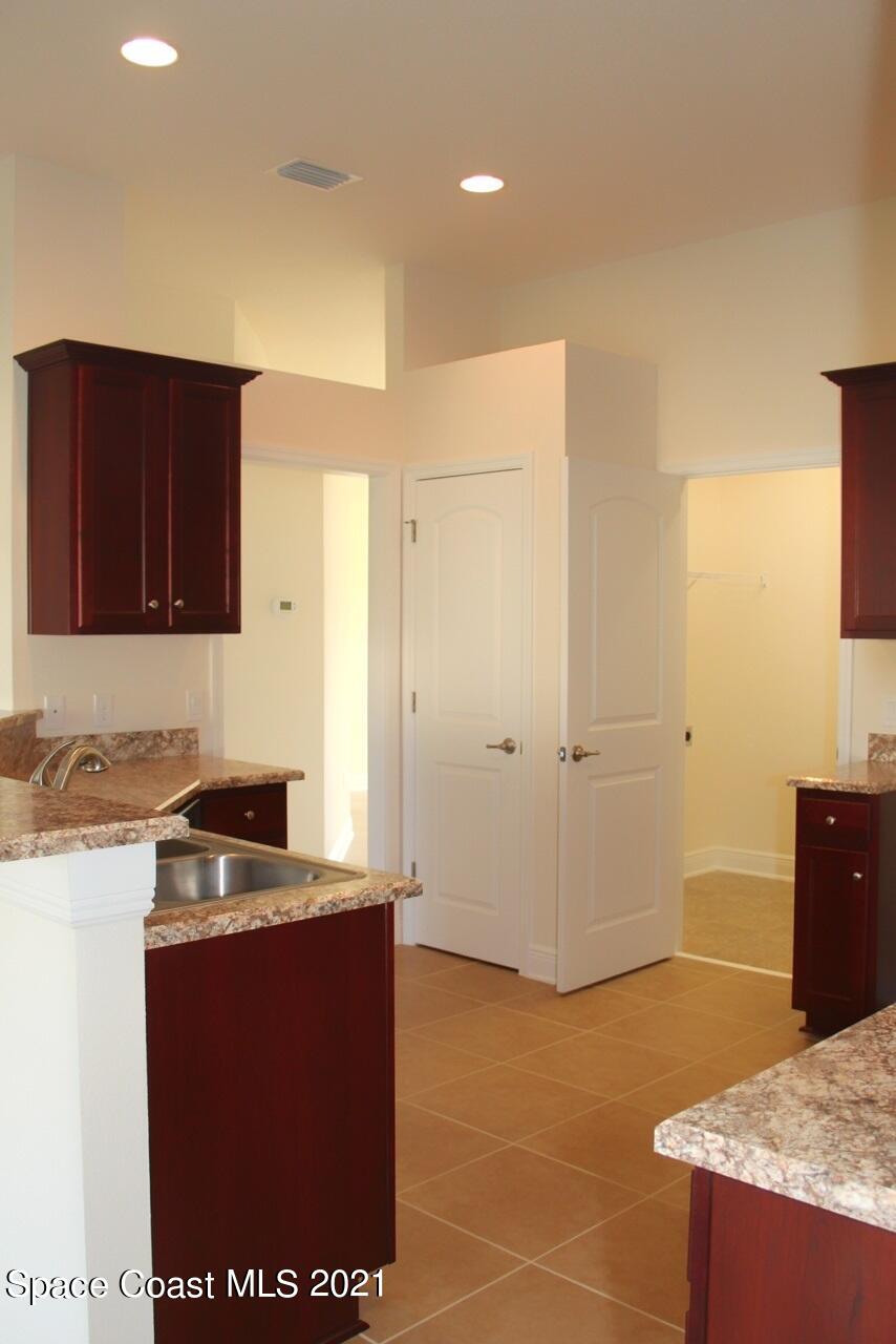 784 Moment Circle Cocoa, FL 32926 - Photo 7 of 14 a kitchen with granite countertop cabinets and black appliances