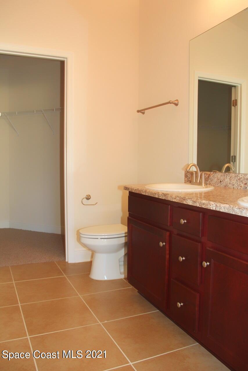 784 Moment Circle Cocoa, FL 32926 - Photo 10 of 14 a bathroom with a toilet a sink and mirror