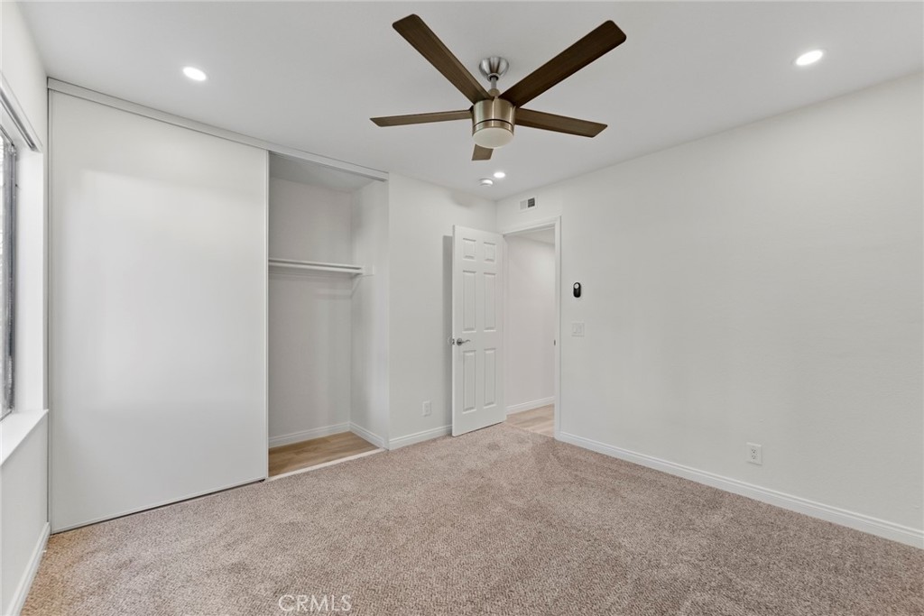 711 West 1st Street Santa Ana, CA 92701 - Photo 14 of 23 en empty room with ceiling fan and windows