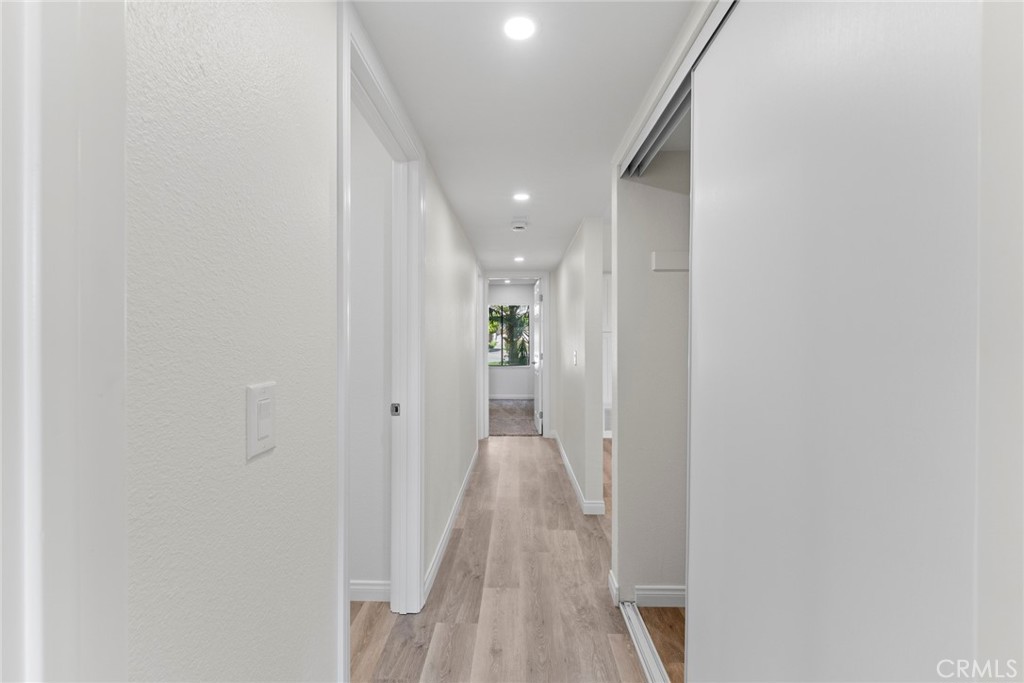 711 West 1st Street Santa Ana, CA 92701 - Photo 16 of 23 a view of a hallway with wooden floor and a bathroom