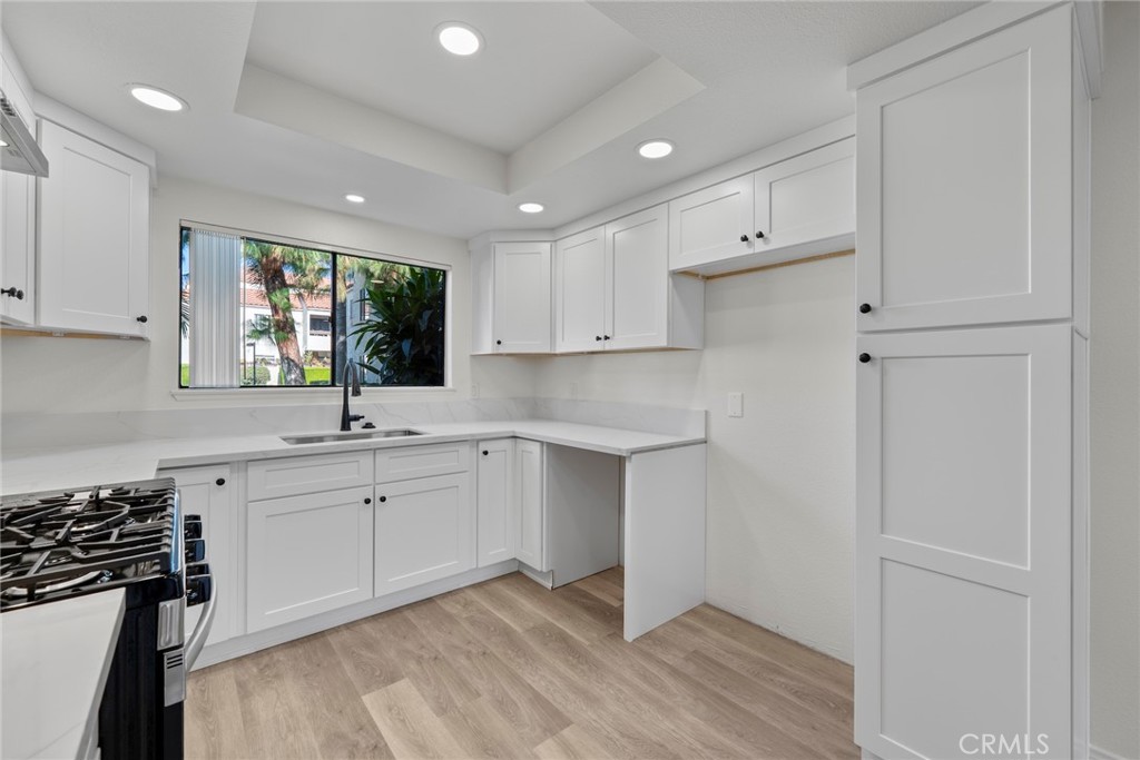 711 West 1st Street Santa Ana, CA 92701 - Photo 3 of 23 a kitchen with a sink cabinets stainless steel appliances and a window