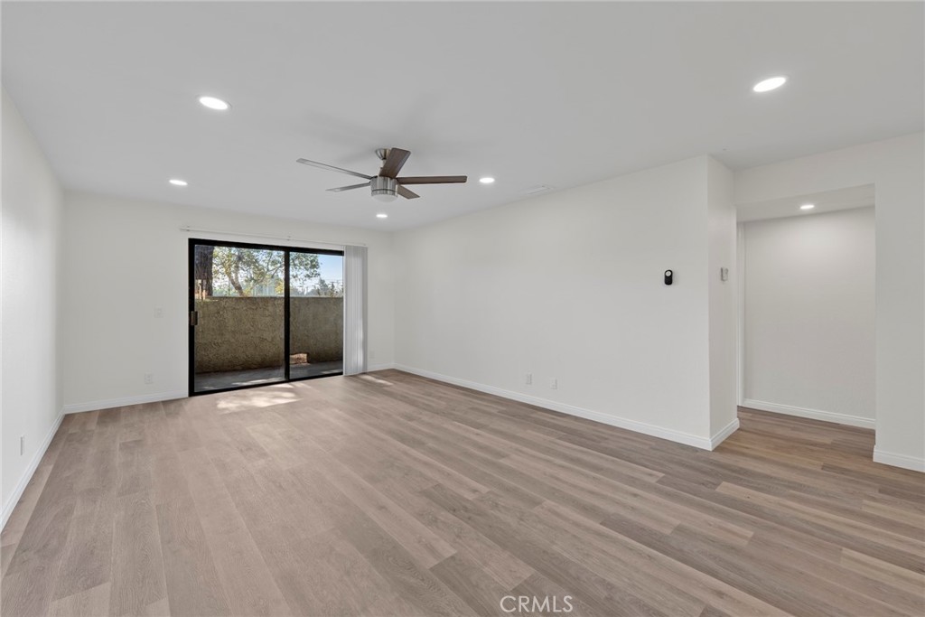 711 West 1st Street Santa Ana, CA 92701 - Photo 5 of 23 a view of an empty room with a window and wooden floor