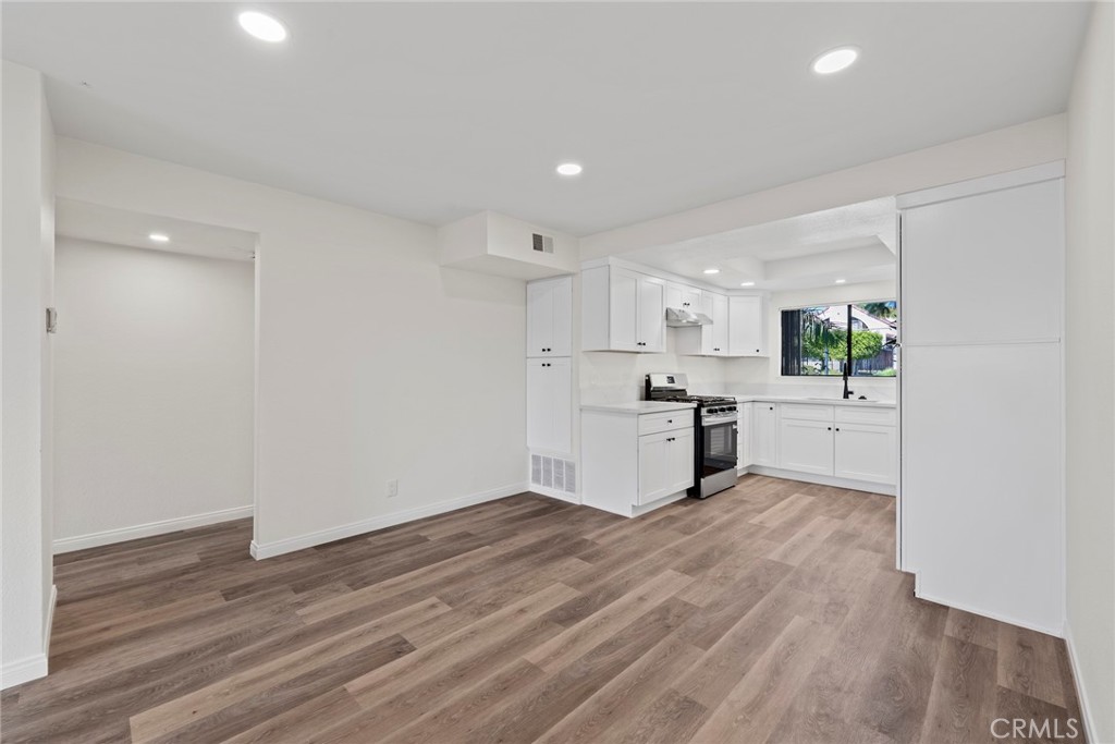 711 West 1st Street Santa Ana, CA 92701 - Photo 6 of 23 a view of a kitchen with wooden floor