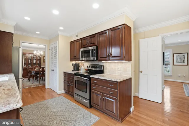 a kitchen with stainless steel appliances granite countertop a stove top oven a sink and a granite counter tops