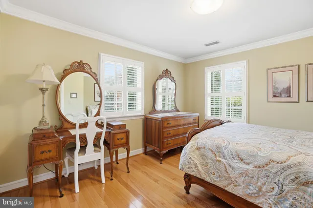 a bedroom with two beds with a dresser