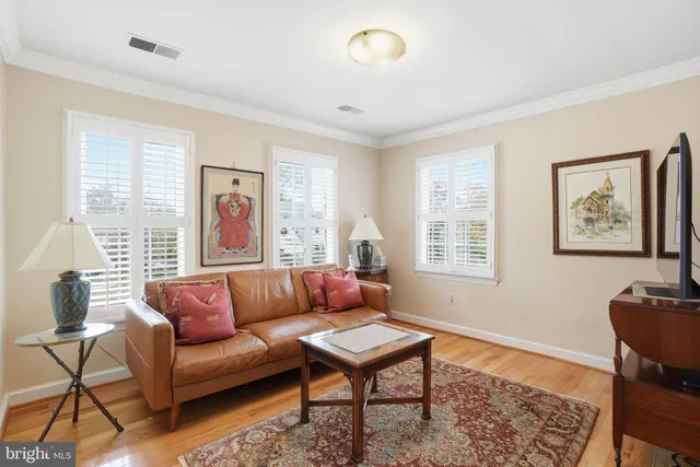 a living room with furniture a rug and a window