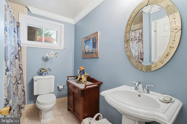 a bathroom with a toilet a sink and a mirror