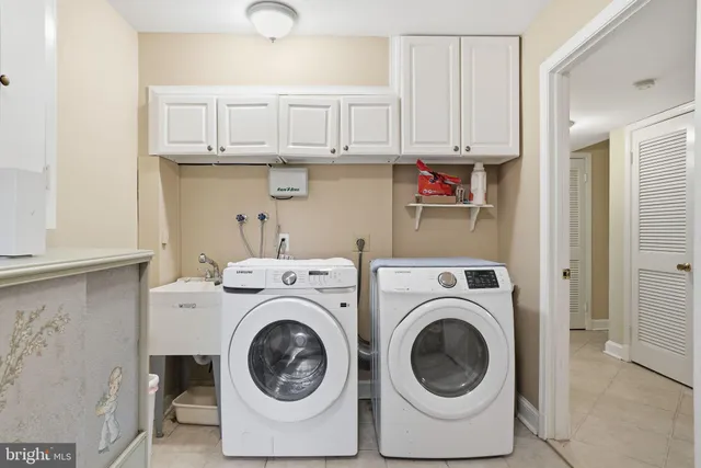 a utility room with sink dryer and washer