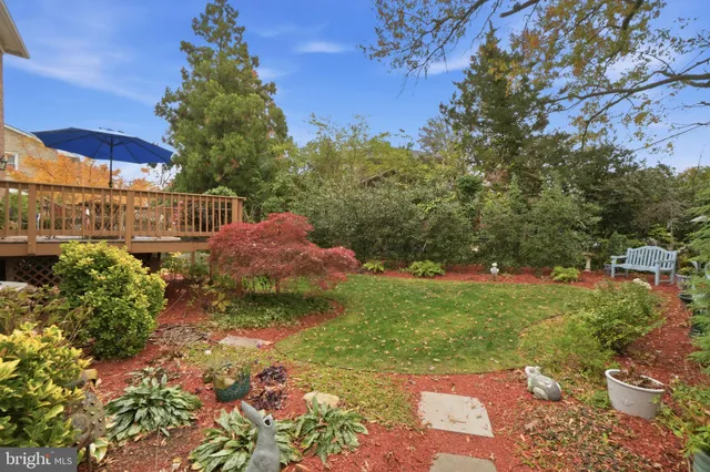 a backyard of a house with a yard and outdoor seating