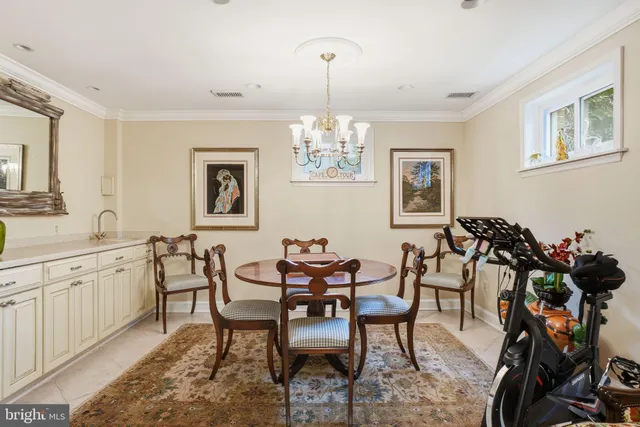 a view of a dining room with furniture and a chandelier