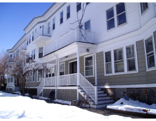 30 Stanton Road, Unit 6 Brookline, MA 02445 - Photo 1 of 1 a front view of a building with a yard