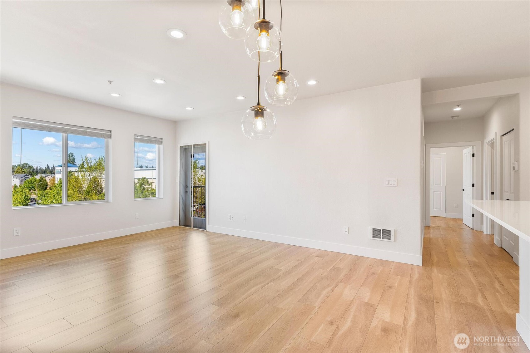14915 38th Drive Southeast, Unit F3011 Bothell, WA 98012 - Photo 12 of 40 an empty room with wooden floor and windows