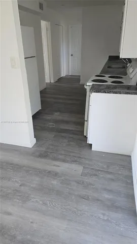 a view of an empty room and a window