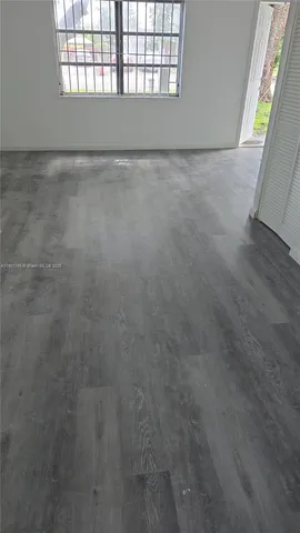 a room with stainless steel appliances wooden cabinets and a sink