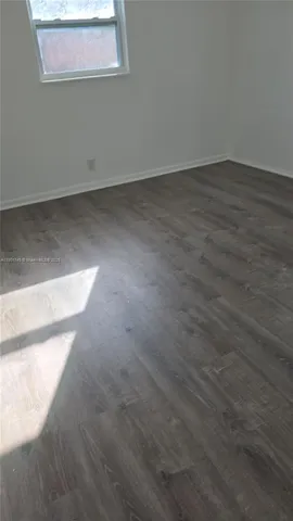 an empty room with wooden floor