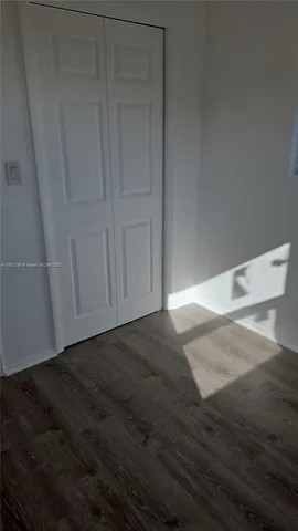 an empty room with wooden floor