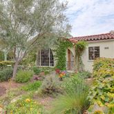 a front view of house with yard and trees around