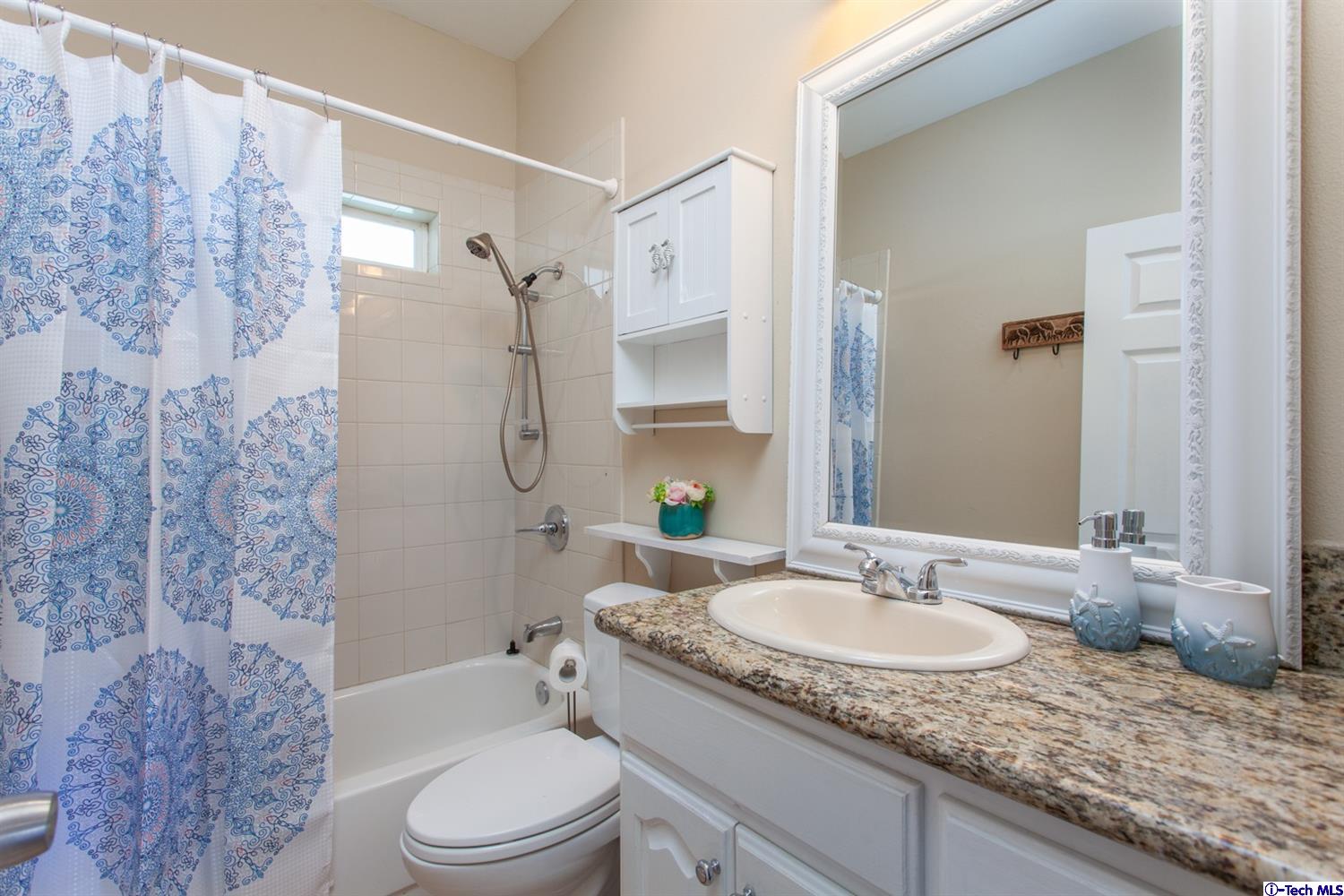 40251 Flintrock Road Leona Valley, CA 93551 - Photo 12 of 32 a bathroom with a granite countertop sink toilet and shower