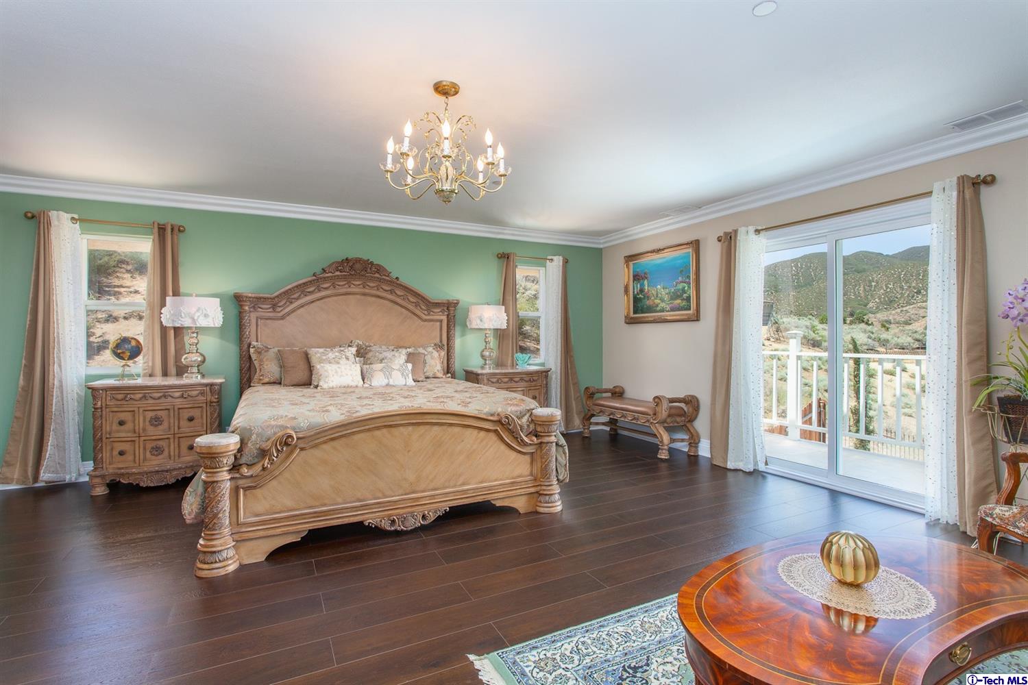40251 Flintrock Road Leona Valley, CA 93551 - Photo 16 of 32 a bedroom with a bed mirror and a table