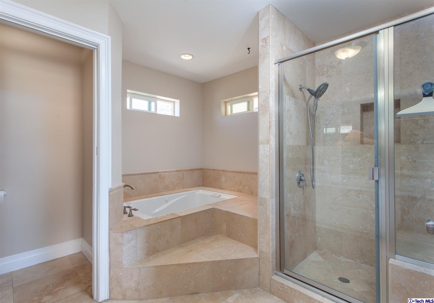 40251 Flintrock Road Leona Valley, CA 93551 - Photo 20 of 32 a bathroom with a tub shower and mirror