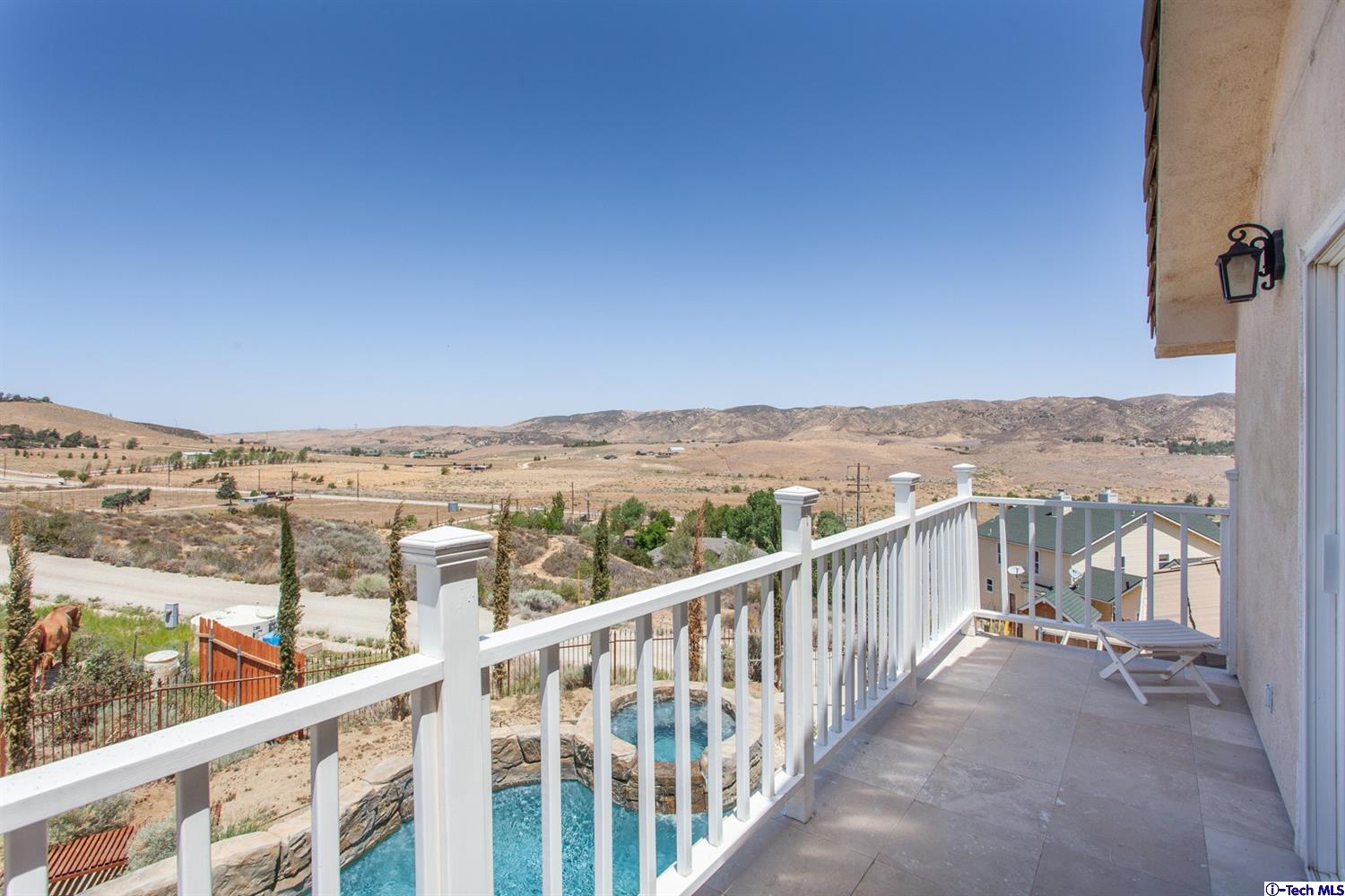 40251 Flintrock Road Leona Valley, CA 93551 - Photo 22 of 32 a view of a city from a balcony