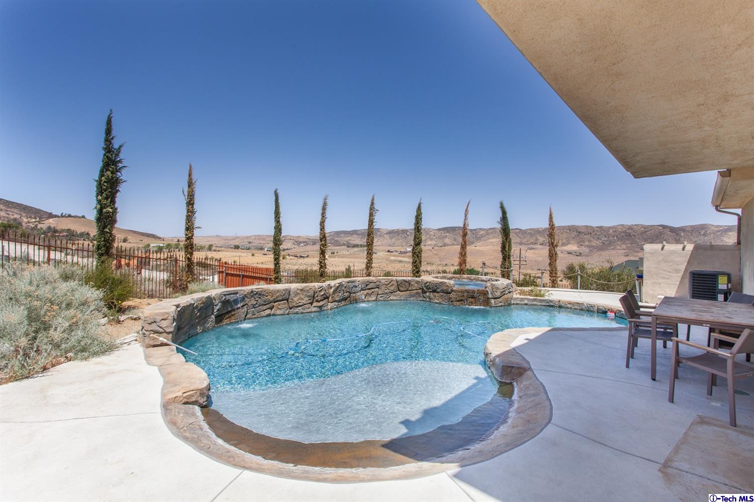 40251 Flintrock Road Leona Valley, CA 93551 - Photo 24 of 32 a view of a swimming pool with outdoor seating