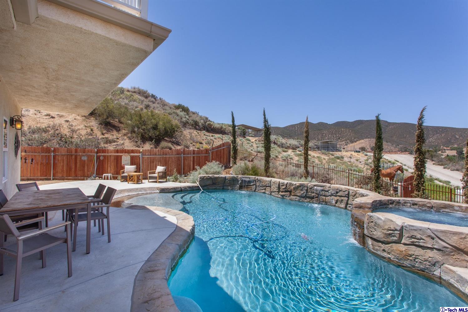 40251 Flintrock Road Leona Valley, CA 93551 - Photo 27 of 32 a view of a swimming pool with outdoor seating