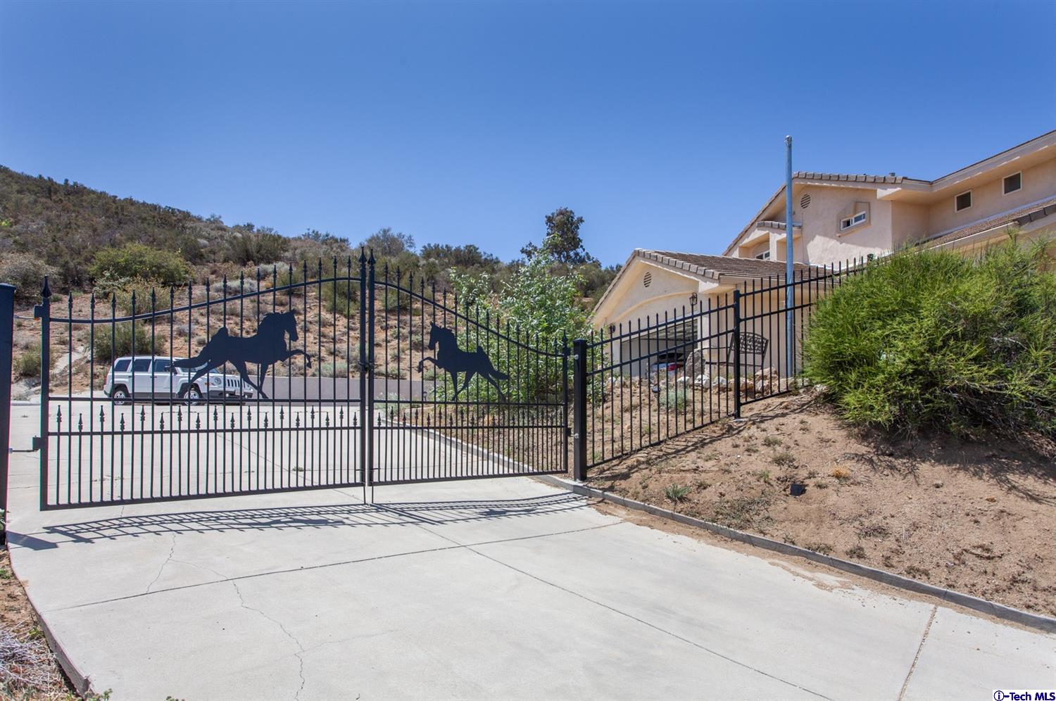 40251 Flintrock Road Leona Valley, CA 93551 - Photo 4 of 32 a view of a wrought iron fences in front of house