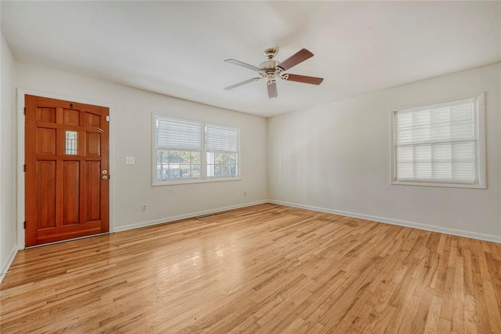 2754 Esquire Way Tucker, GA 30084 - Photo 14 of 49 a view of an empty room with wooden floor and a window