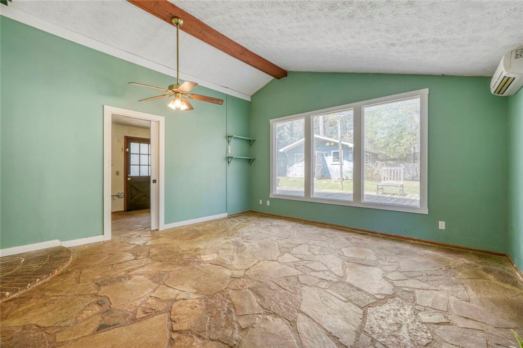 2754 Esquire Way Tucker, GA 30084 - Photo 20 of 49 a view of an empty room with window and chandelier fan