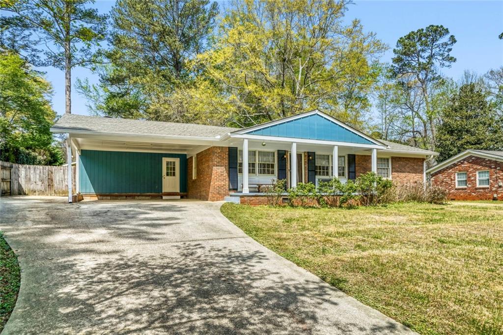 2754 Esquire Way Tucker, GA 30084 - Photo 2 of 49 a front view of a house with a garden