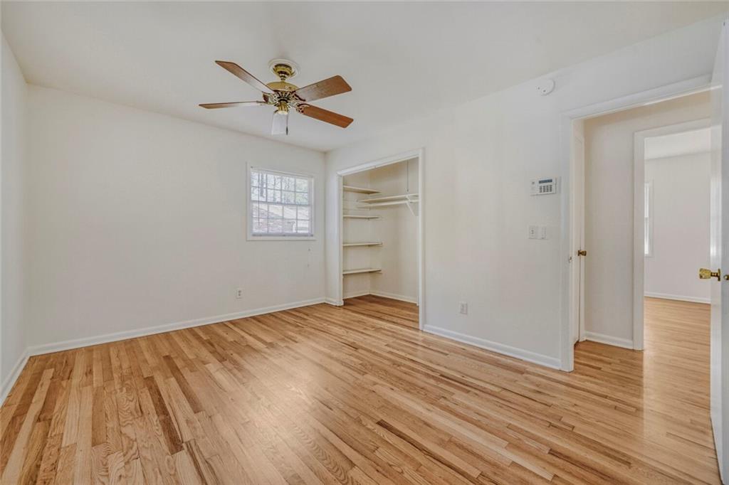 2754 Esquire Way Tucker, GA 30084 - Photo 24 of 49 a view of an empty room with wooden floor and a ceiling fan