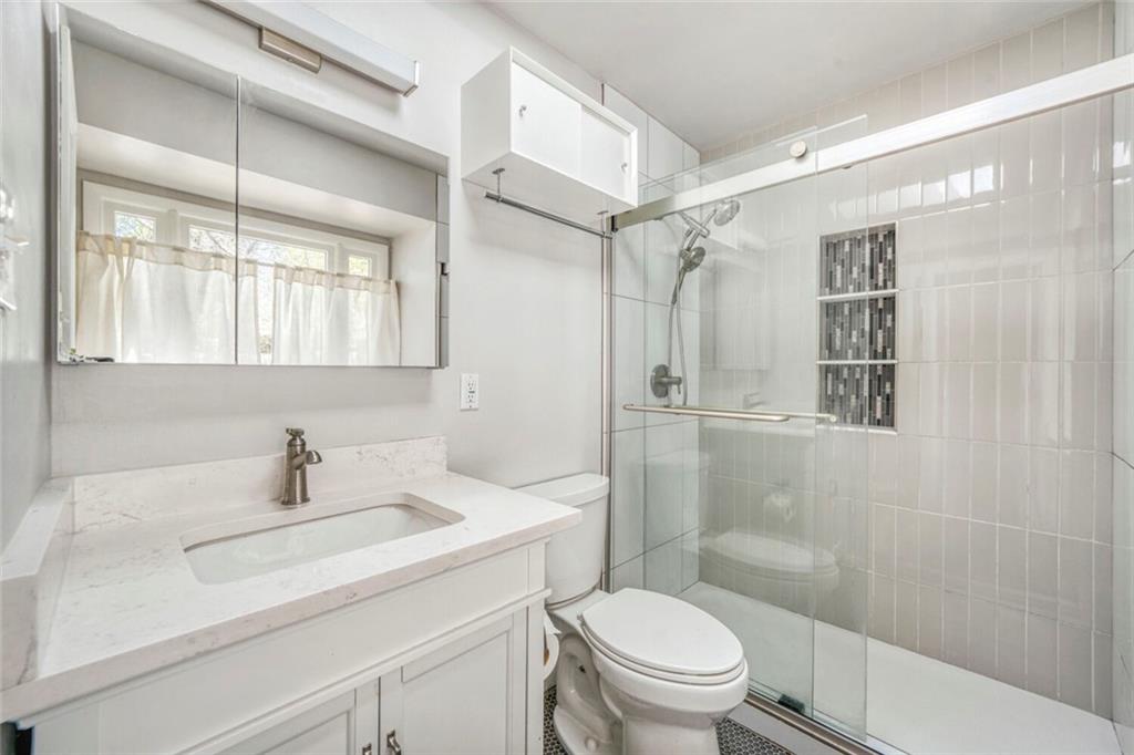 2754 Esquire Way Tucker, GA 30084 - Photo 26 of 49 a bathroom with a sink toilet a mirror and shower